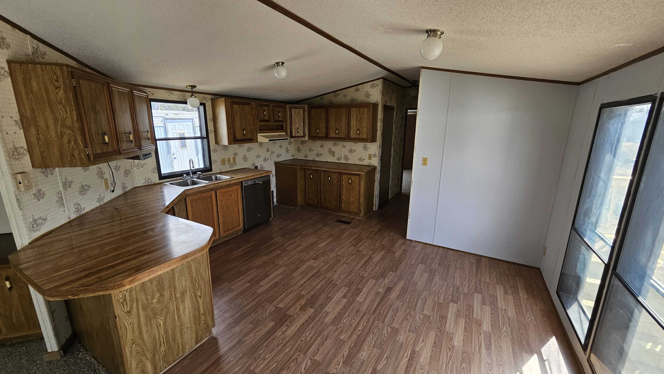 3-bedroom, 2-bathroom home for sale or rent in Eastside Mobile Home Park with ample storage and bright living spaces.