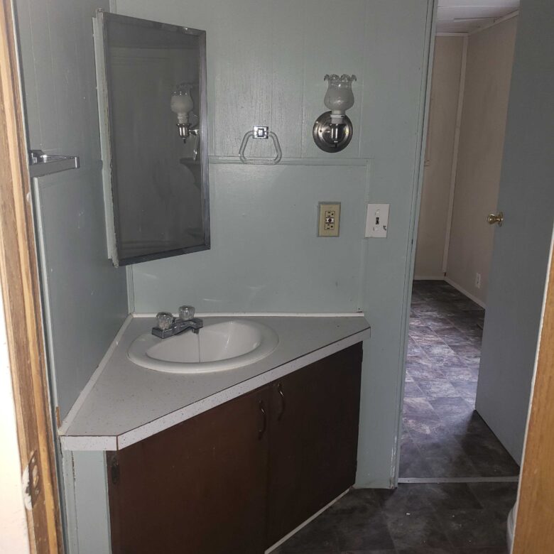 2-bedroom, 1-bathroom home for sale or rent-to-own in North Acres Mobile Home Park with a primary suite, walk-in closet, and modern accents.