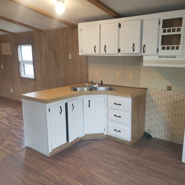 2-bedroom, 1-bathroom home for sale or rent-to-own in Carman Terrace Mobile Home Park with bright living spaces and a woody-like interior.