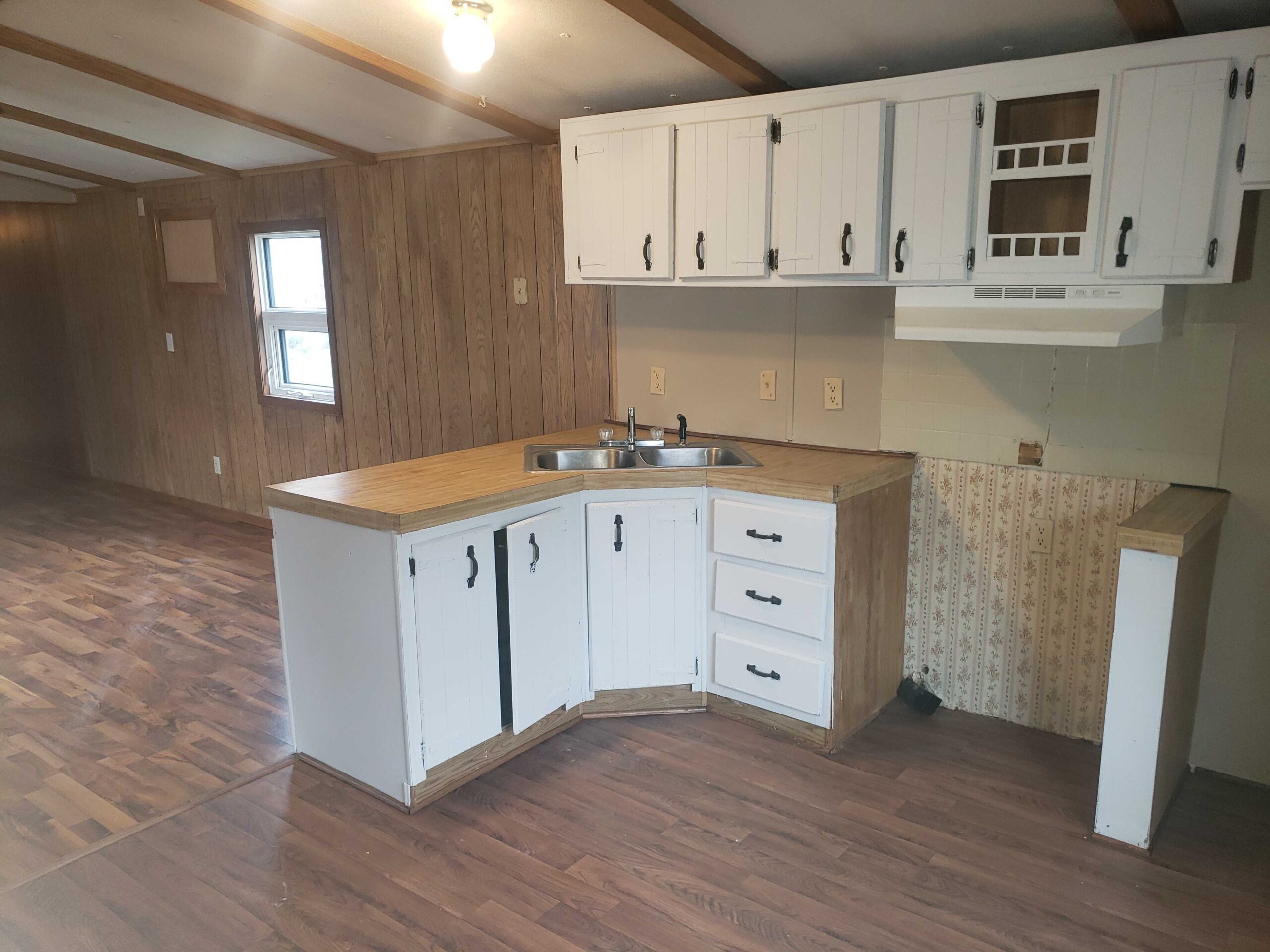 2-bedroom, 1-bathroom home for sale or rent-to-own in Carman Terrace Mobile Home Park with bright living spaces and a woody-like interior.