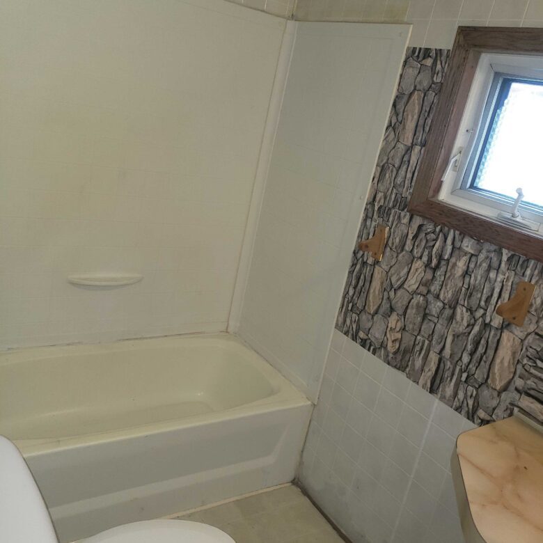 2-bedroom, 1-bathroom home for sale or rent-to-own in Carman Terrace Mobile Home Park with bright living spaces and a woody-like interior.
