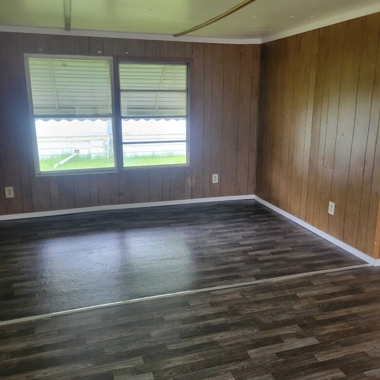 2-bedroom, 1-bathroom home for sale or rent-to-own in Saginaw Mobile Home Park with bright living spaces, a woody-like interior, and a convenient kitchen.