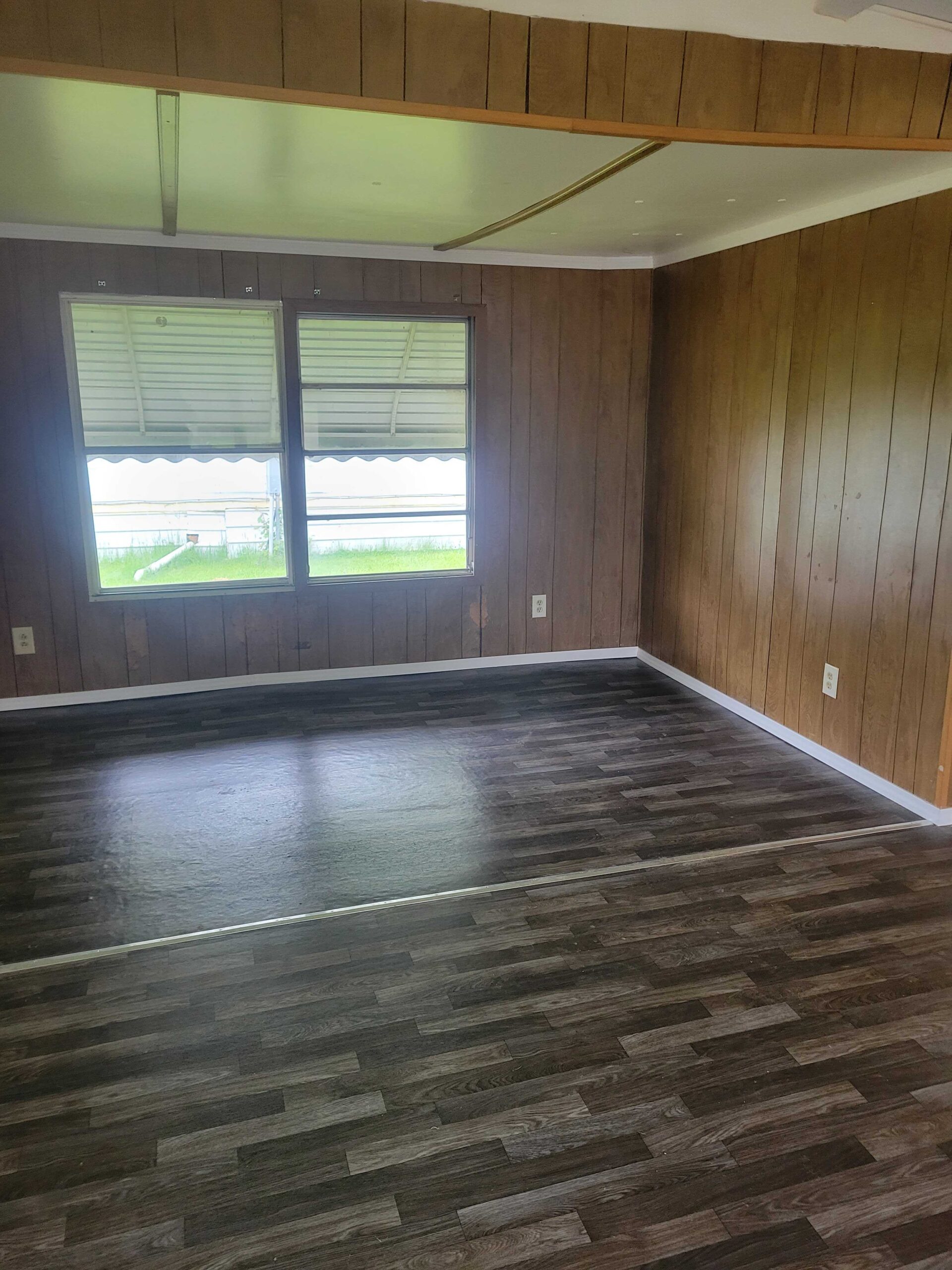 2-bedroom, 1-bathroom home for sale or rent-to-own in Saginaw Mobile Home Park with bright living spaces, a woody-like interior, and a convenient kitchen.