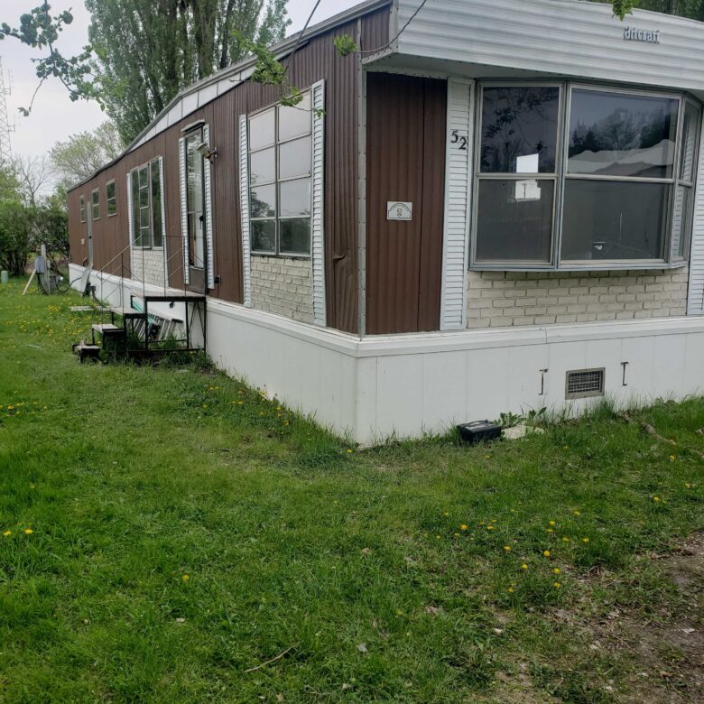 3-bedroom, 1-bathroom home for sale or rent-to-own in Carman Terrace Mobile Home Park with bright living spaces and a woody-like interior.