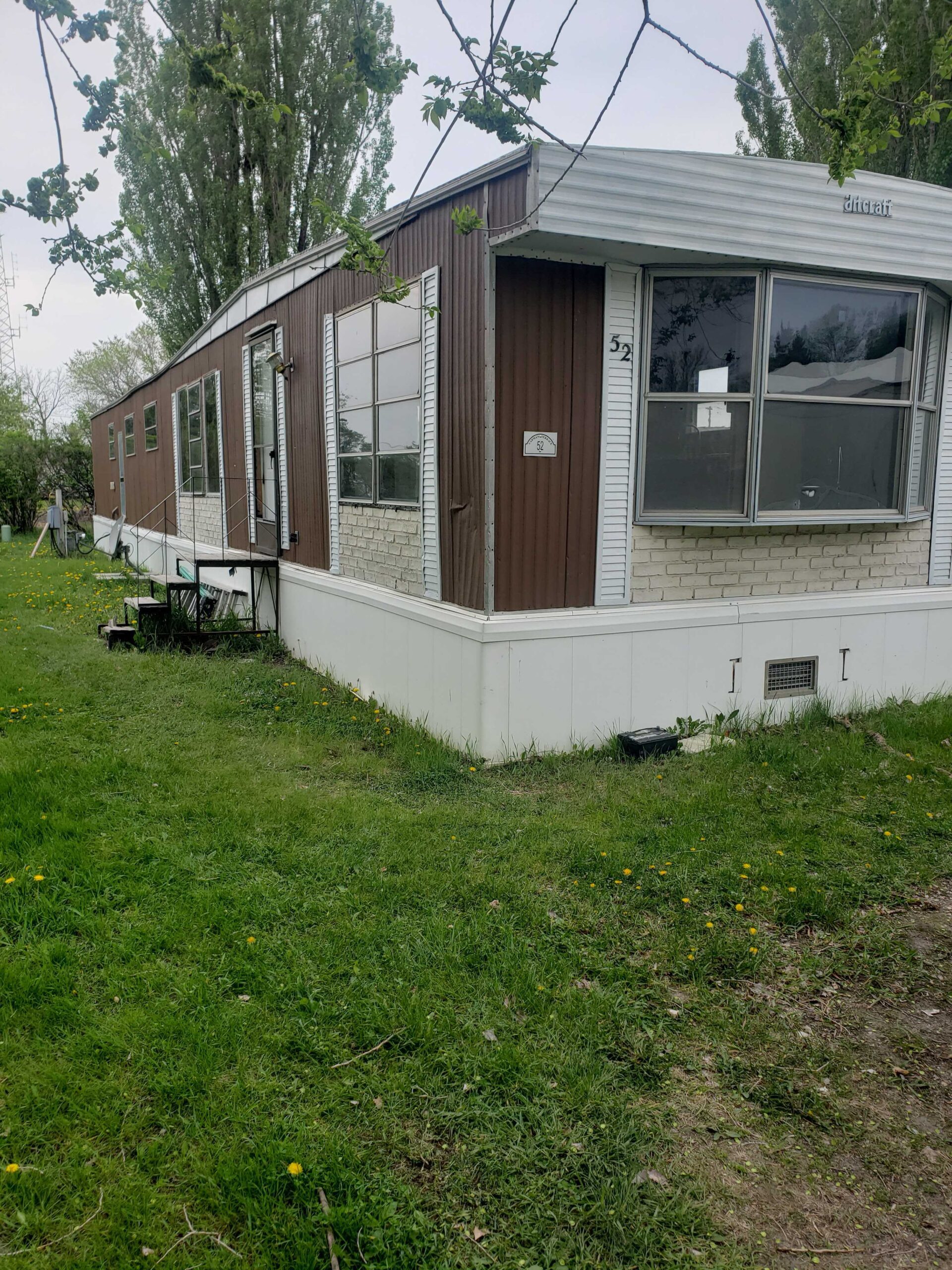 3-bedroom, 1-bathroom home for sale or rent-to-own in Carman Terrace Mobile Home Park with bright living spaces and a woody-like interior.