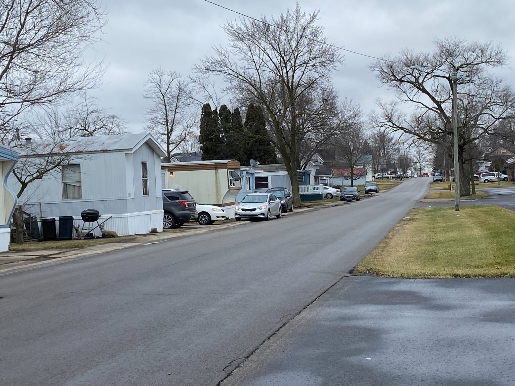 Spacious mobile home with a landscaped yard at Berne Mobile Home Park