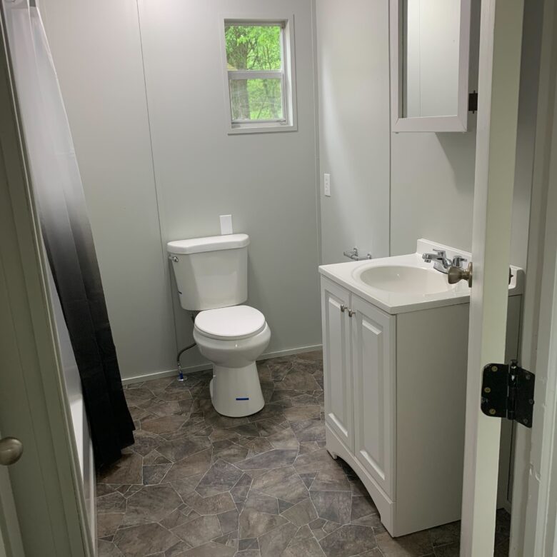 Renovated 2-bedroom, 1-bathroom home for sale or rent-to-own in Hayfield Estates with a bright, open-concept kitchen and charming porch entrance.