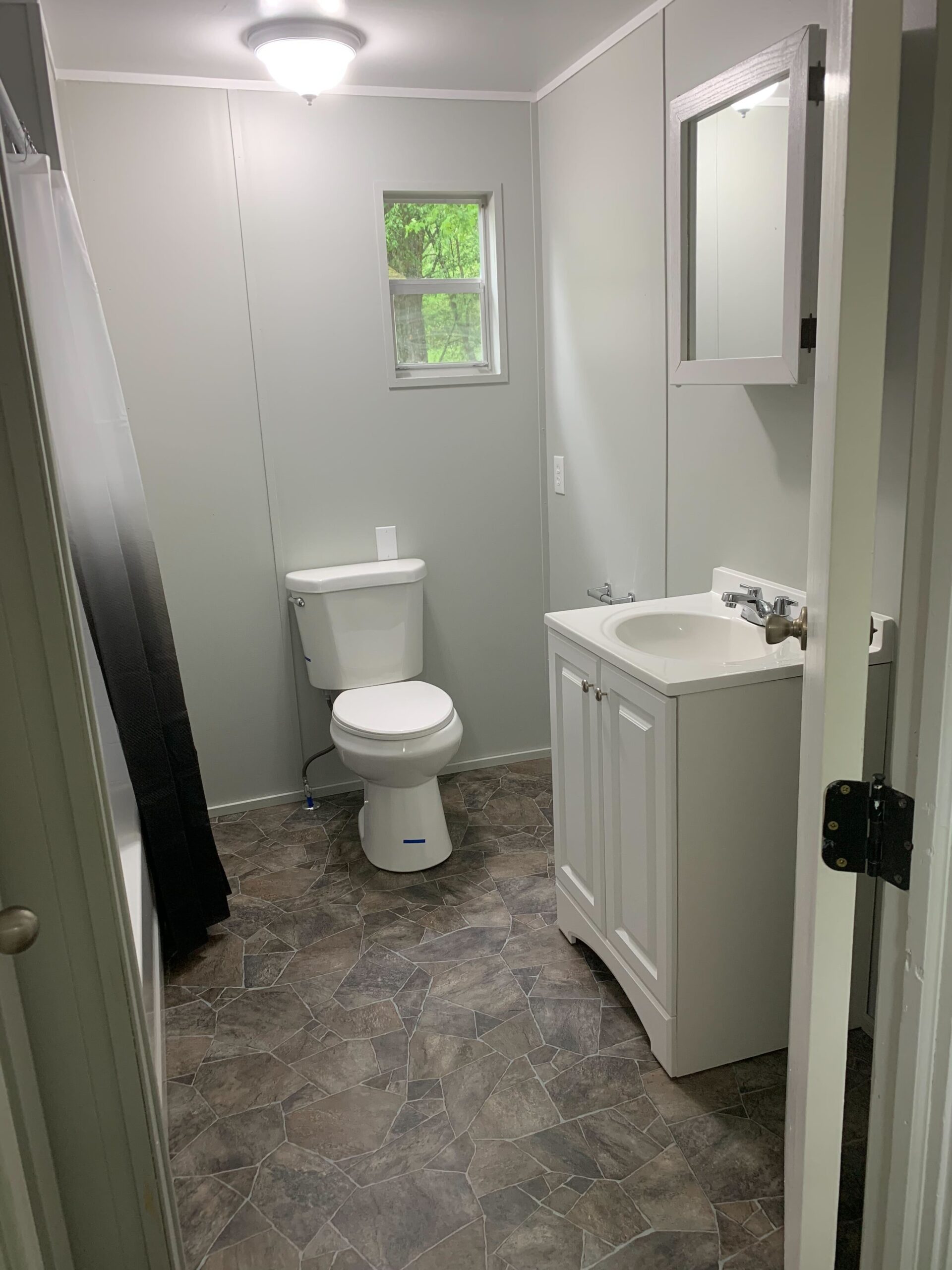 Renovated 2-bedroom, 1-bathroom home for sale or rent-to-own in Hayfield Estates with a bright, open-concept kitchen and charming porch entrance.