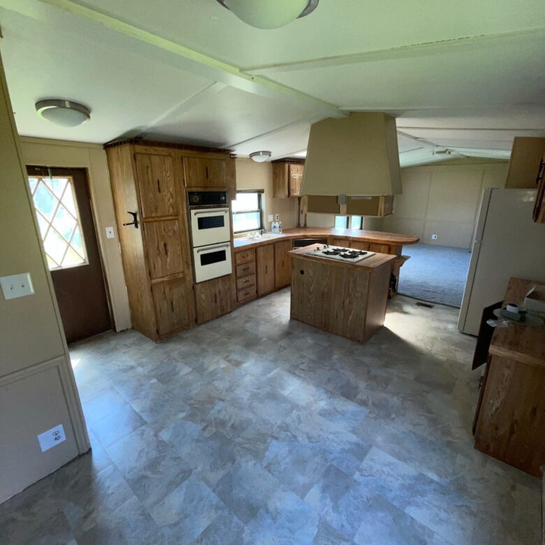 2-bedroom, 2-bathroom home for sale or rent-to-own in Willow Haven Mobile Home Park with lakeside views, bright living spaces, and a well-equipped kitchen.