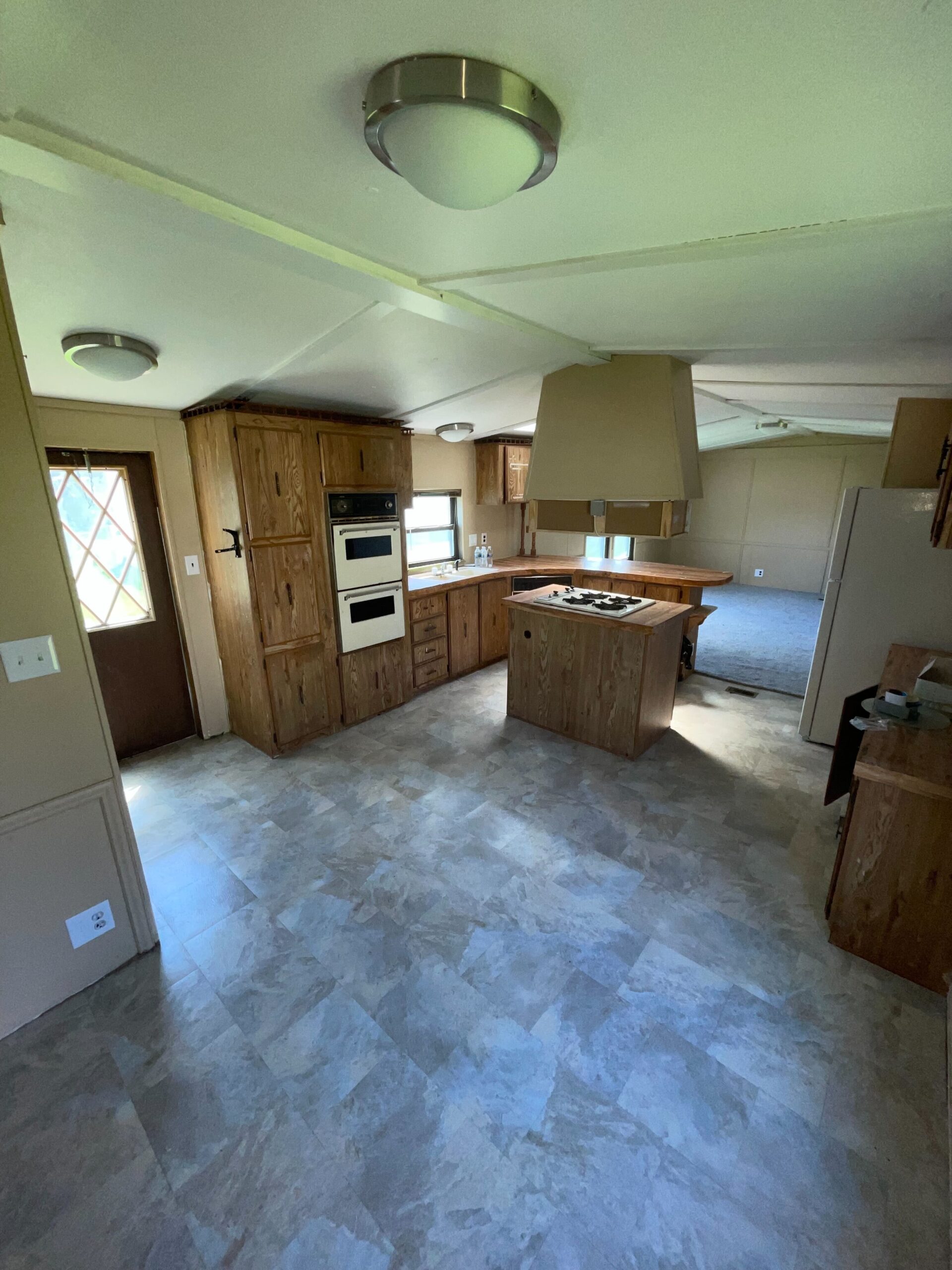 2-bedroom, 2-bathroom home for sale or rent-to-own in Willow Haven Mobile Home Park with lakeside views, bright living spaces, and a well-equipped kitchen.