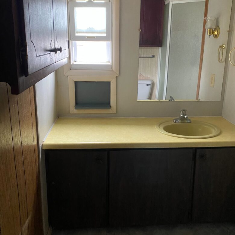 Cozy 1-bedroom, 1-bathroom home in Berne Mobile Home Park with bright living spaces and a woody-like interior